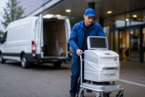 Medical courier delivering medical equipment outside a healthcare facility in Birmingham